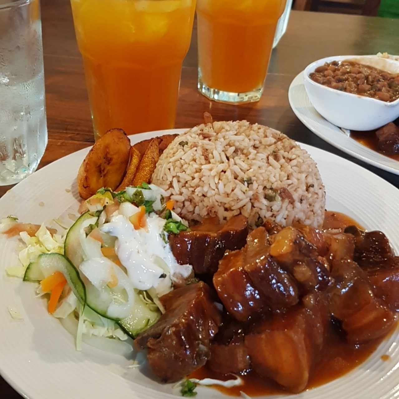 Menú del día con costillitas y al fondo chicha de limón con raspadura 