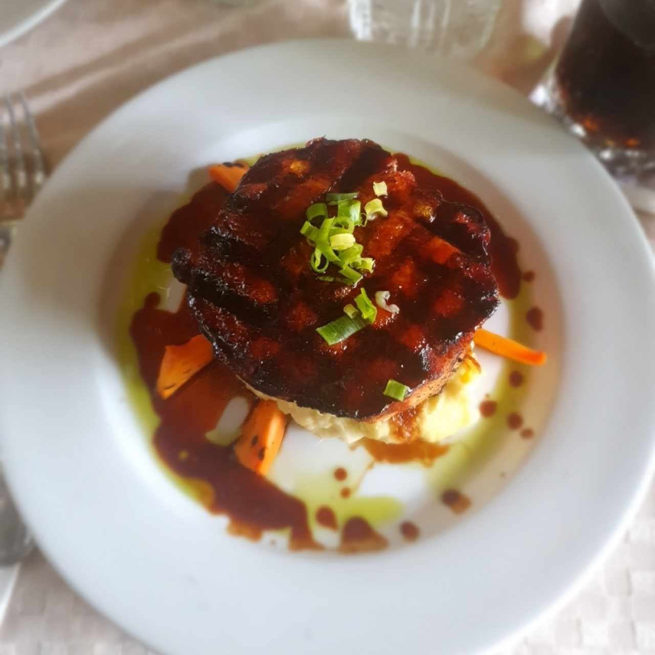 Chuleta de cerdo ahumada a la grilla con miel de caña dulce y puré de ñame