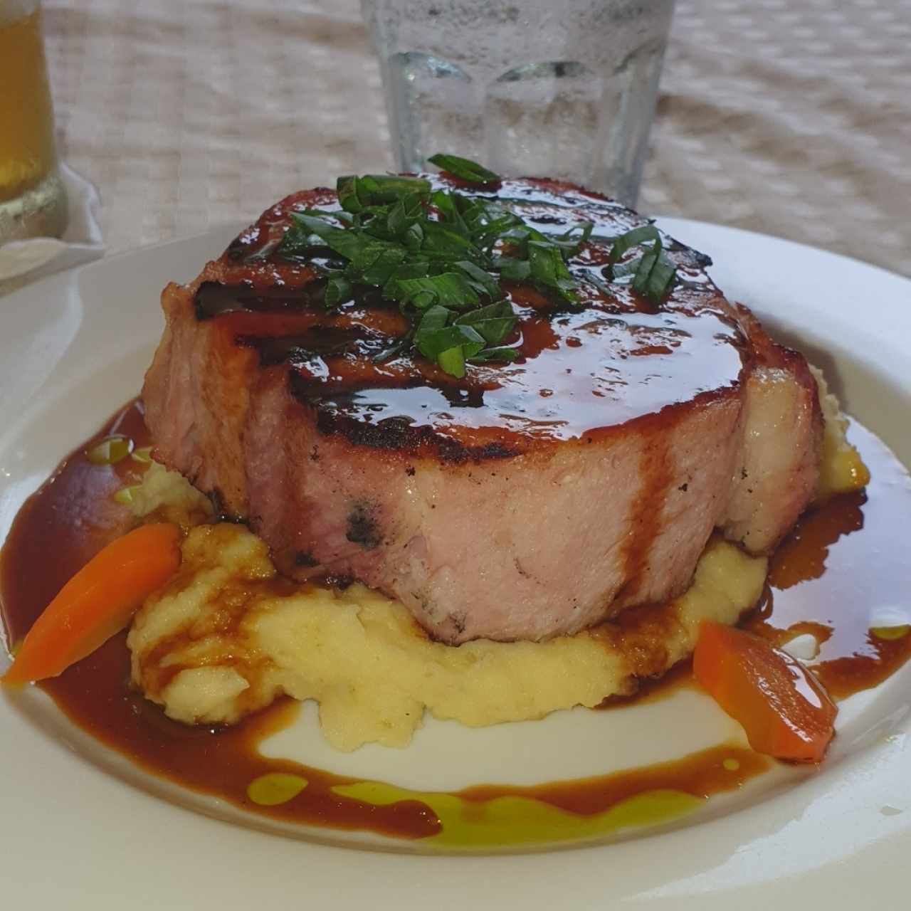 Chuleta de cerdo ahumada a la grilla con miel de caña dulce y puré de ñame