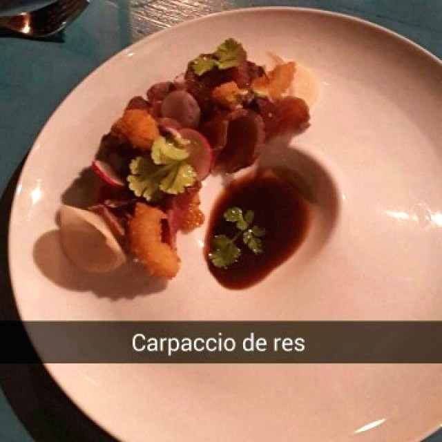 Carpaccio de res ahumada en su jugo trufada, rábano encurtido y tempura de cebolla