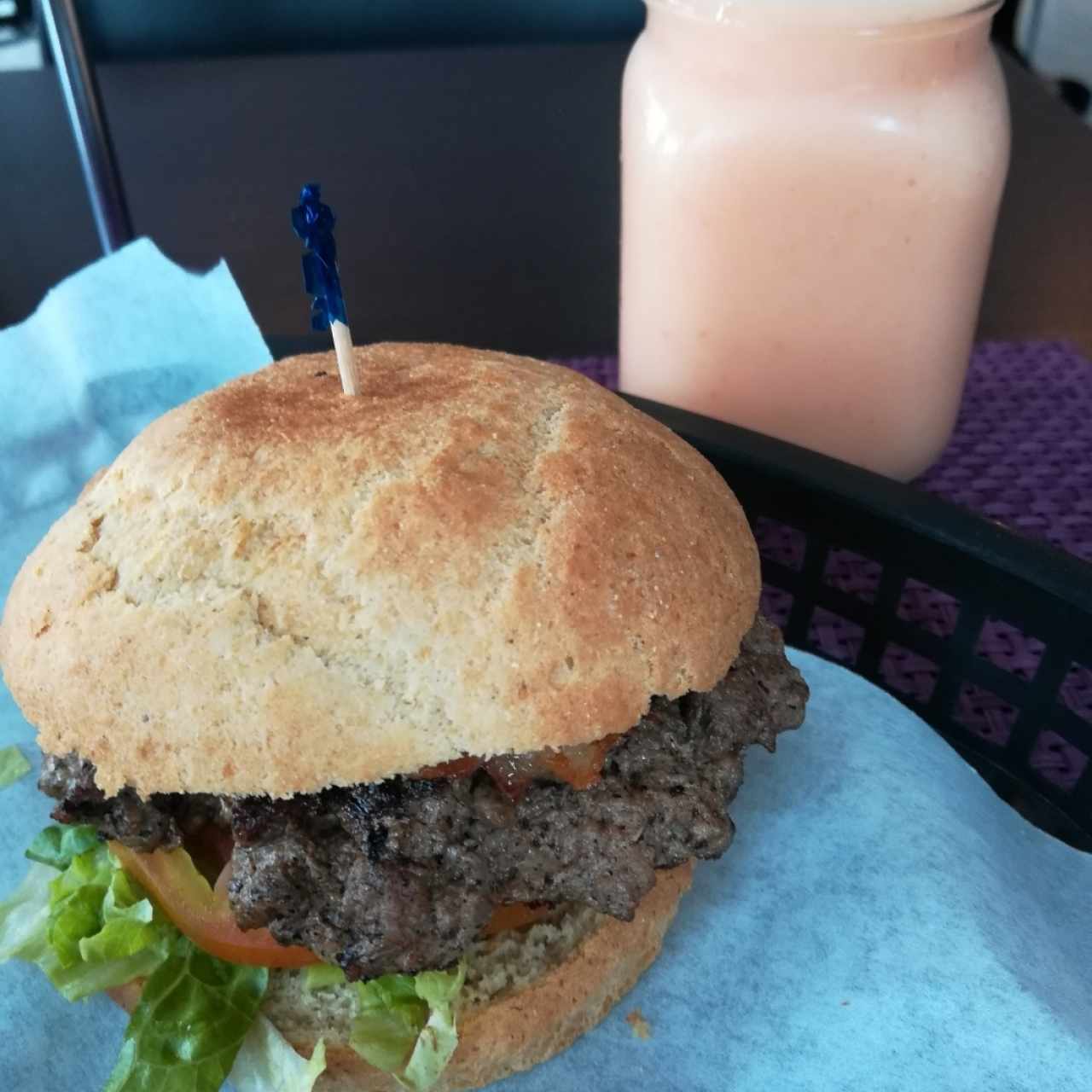 deliciosa y jugosa hamburguesa con pan libre de gluten y jugo ponche de frutas