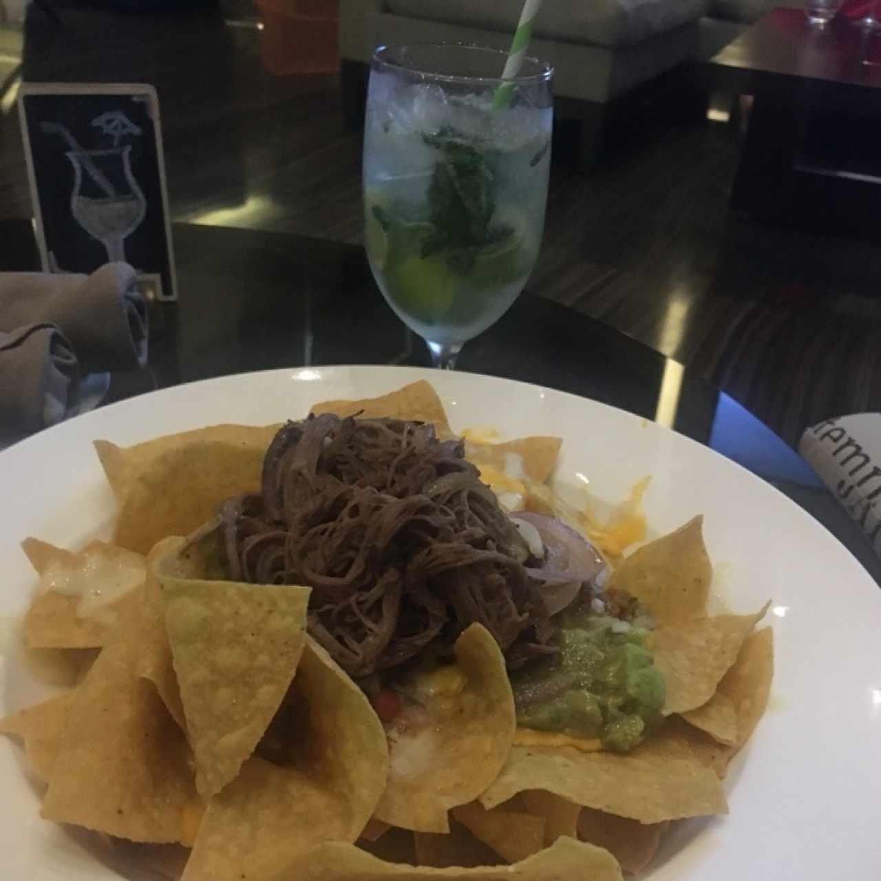 Nachos y aconpsñafoa de un delicioso mojito