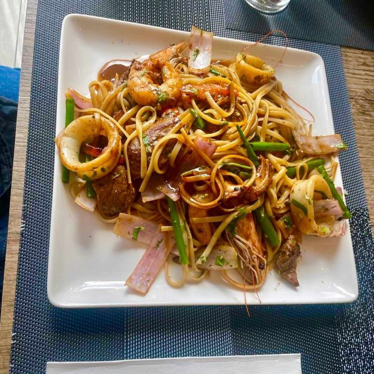 LOMO SALTADO MAR Y TIERRA (Trozos de Filete de Res, Calamar, Camarón, Pulpo, Cebolla Morada, Tomate en Salsa de Soja, Ostión, Papas Fritas y Arroz).