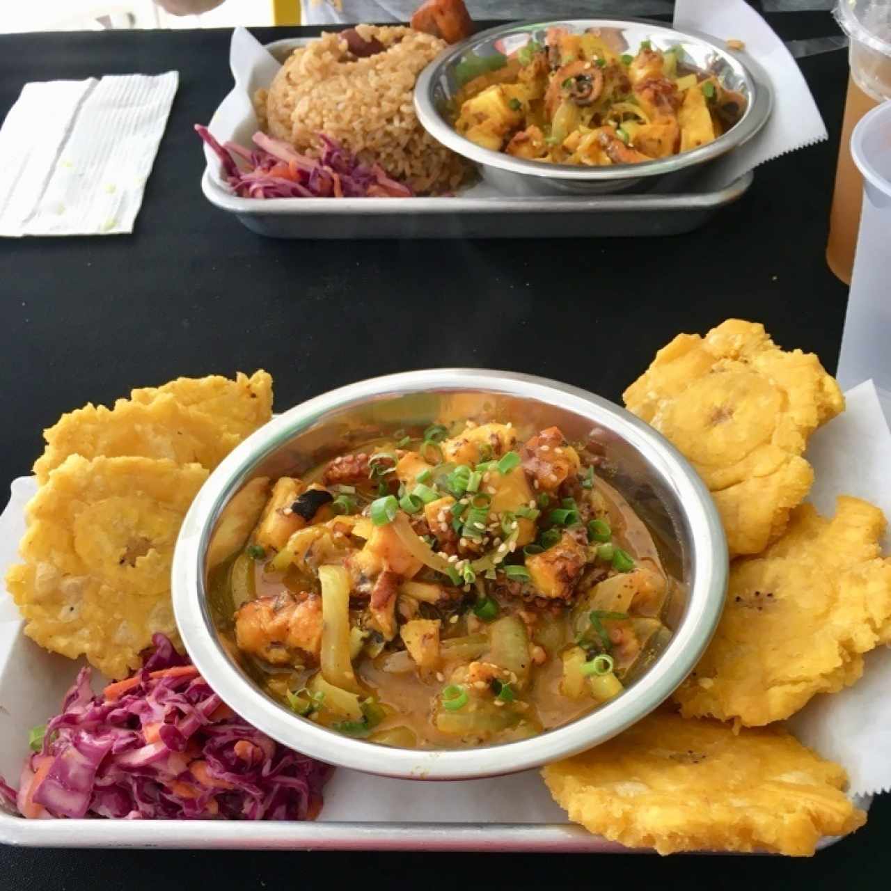 pulpo en leche de coco con patacones y otro plato acompañado con arroz con coco