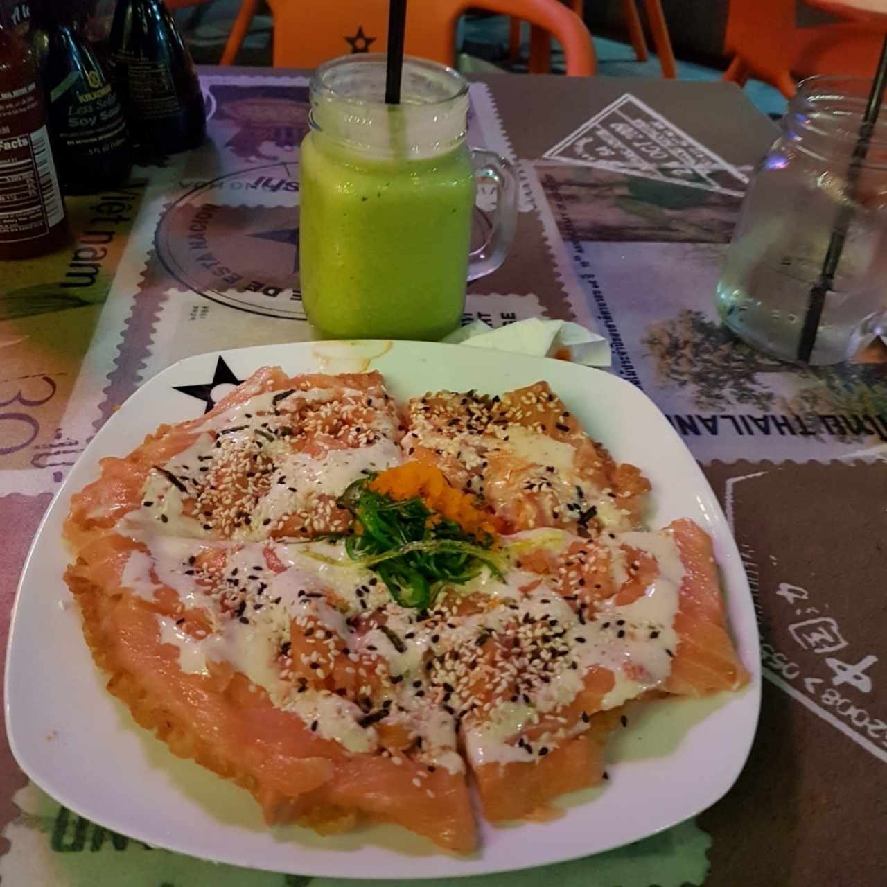 Pizza de Sushi de salmón ahumado acompañado de Jugo Nación preparada con naranja, piña, albahaca y miel