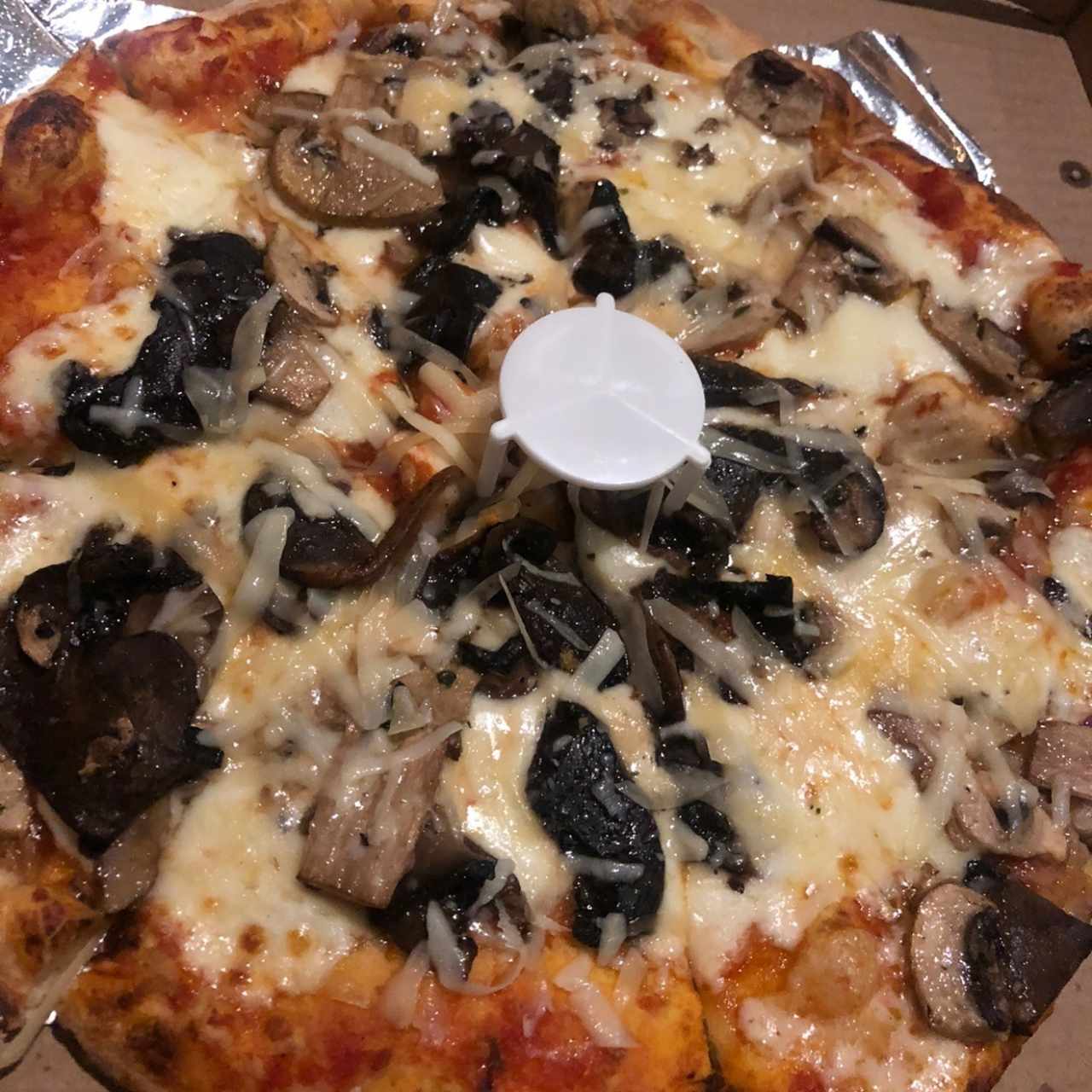 Pizza de hongos oscuros y blancos