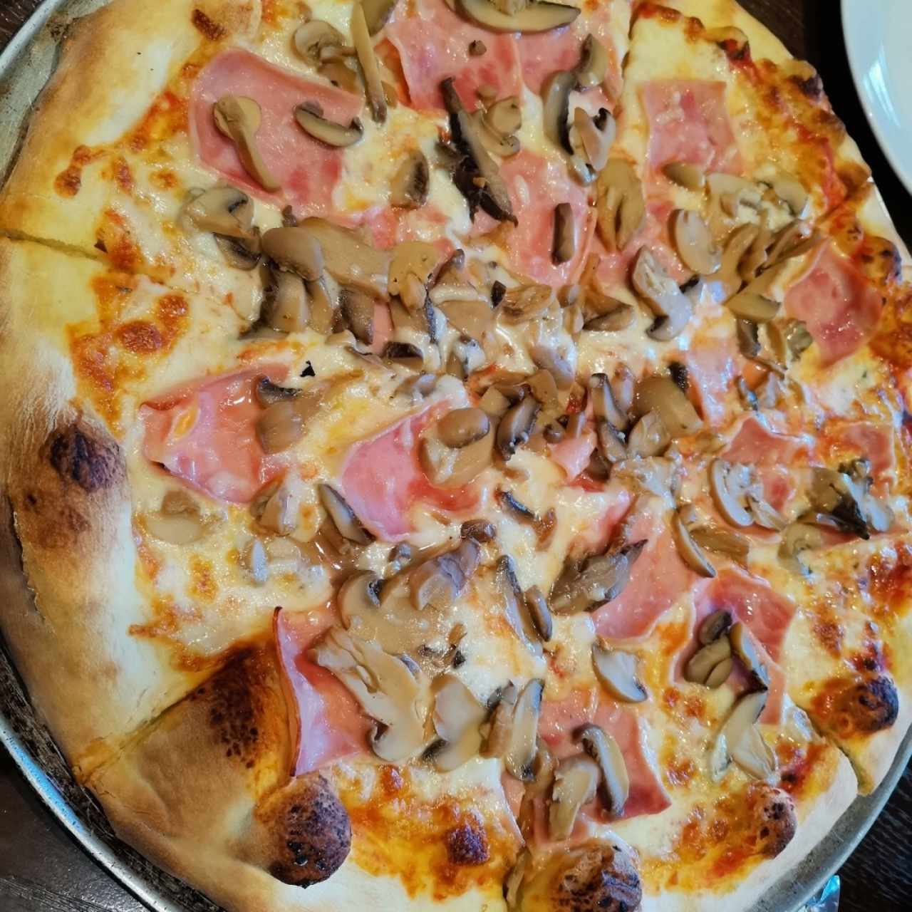 Pizza de jamón y hongos. 