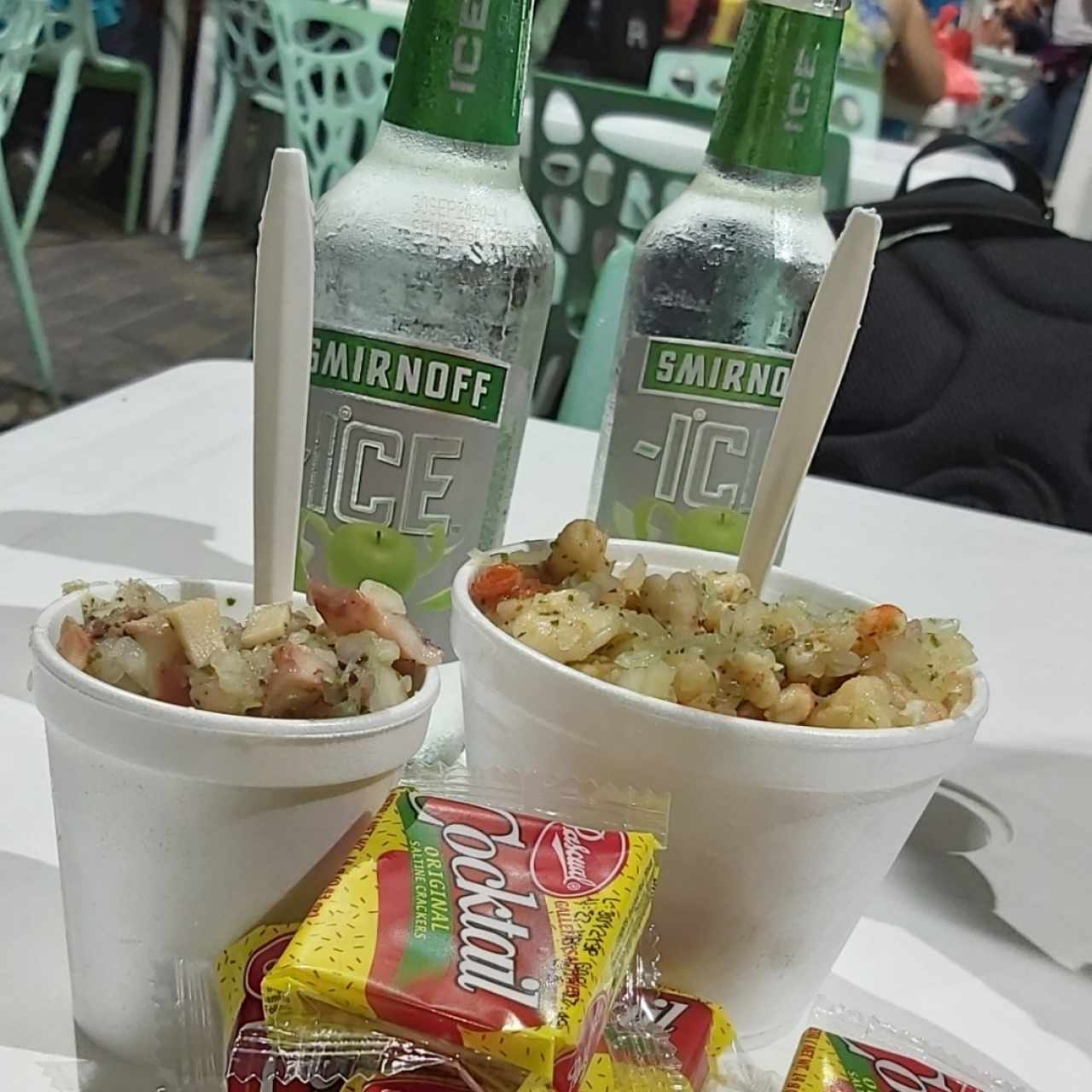 Una pinta de ceviche de camarones, un ceviche mixto y dos smirnoff manzanita. 