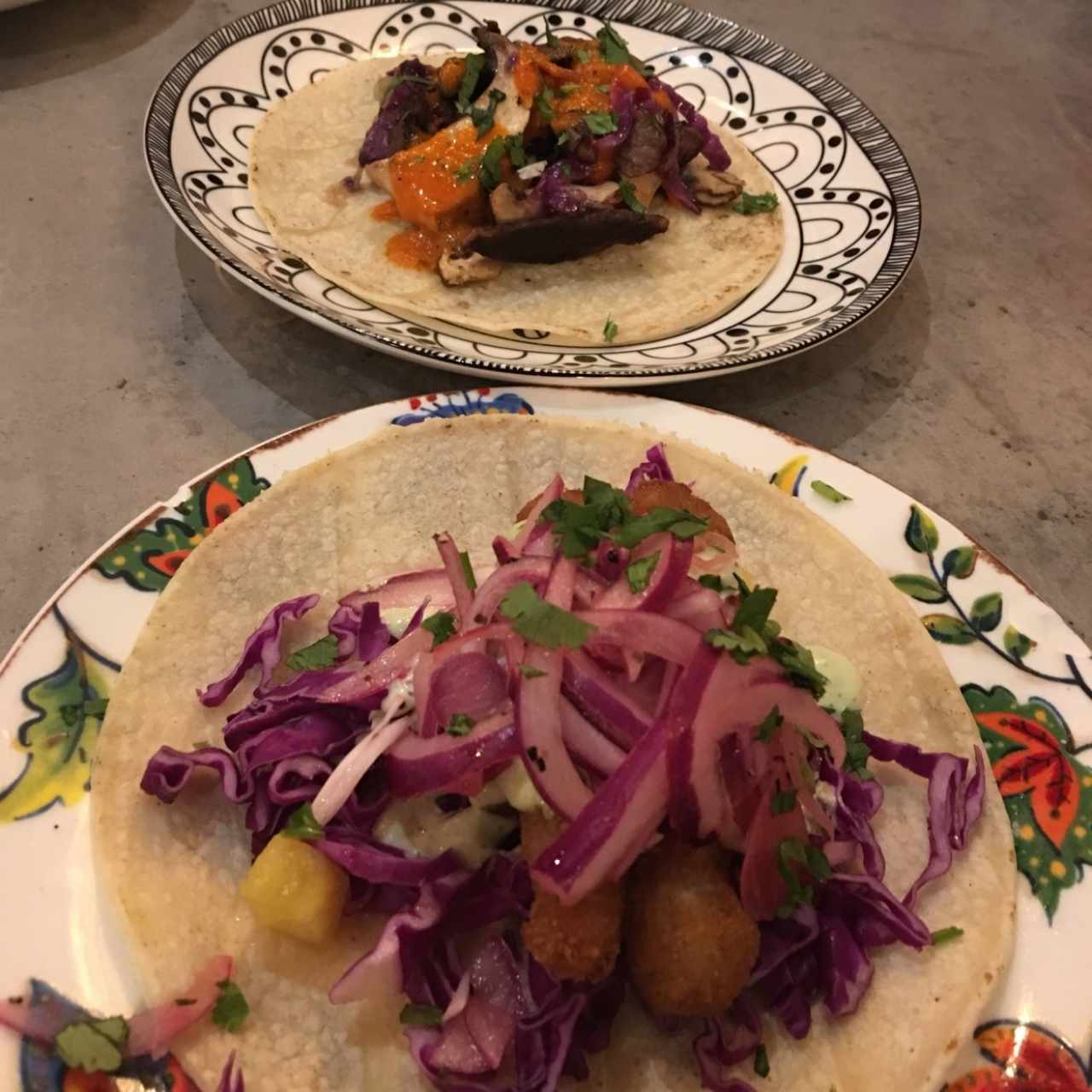 Taco de pescado y de fondo el de queso frito. 