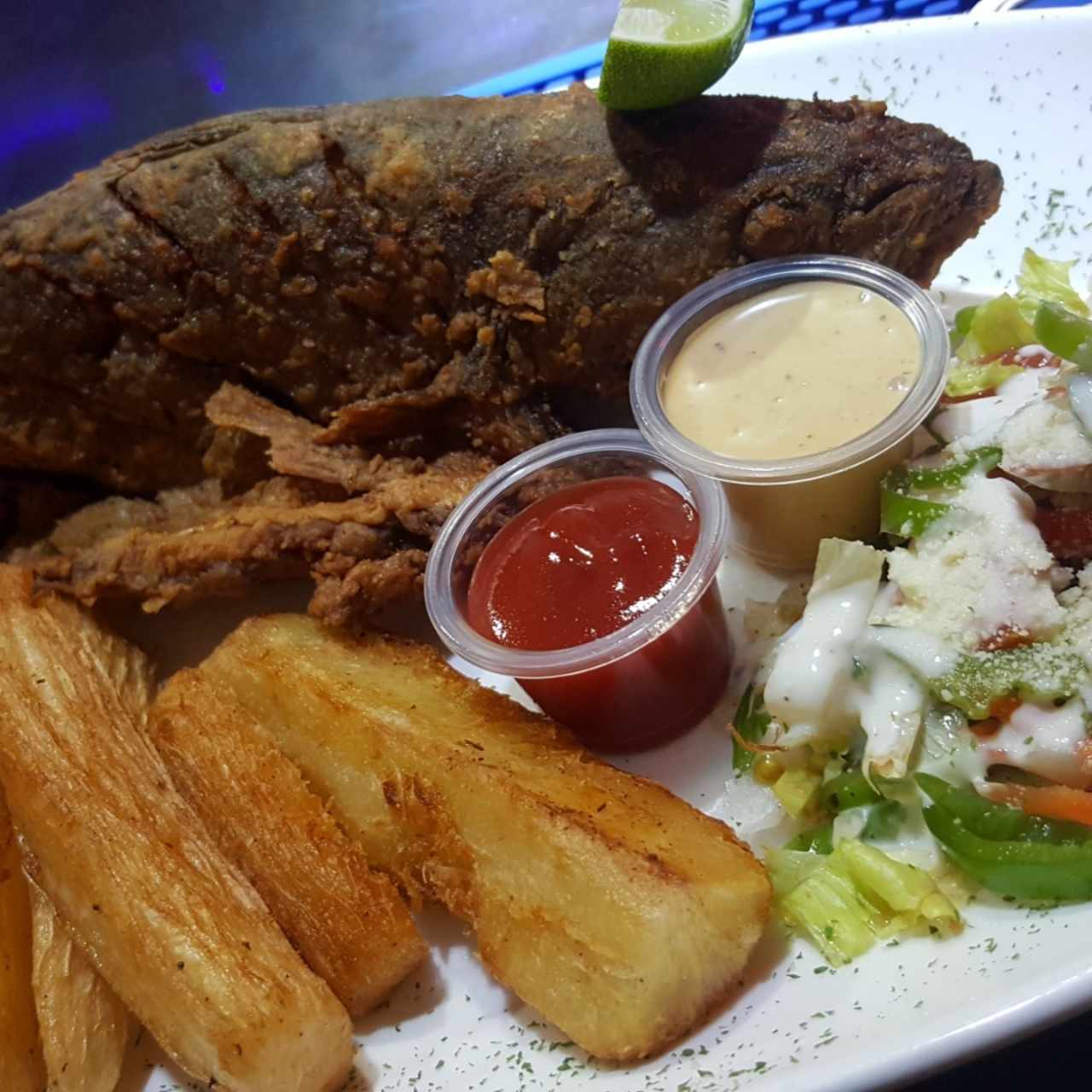 Pescado frito acompañado de yucas