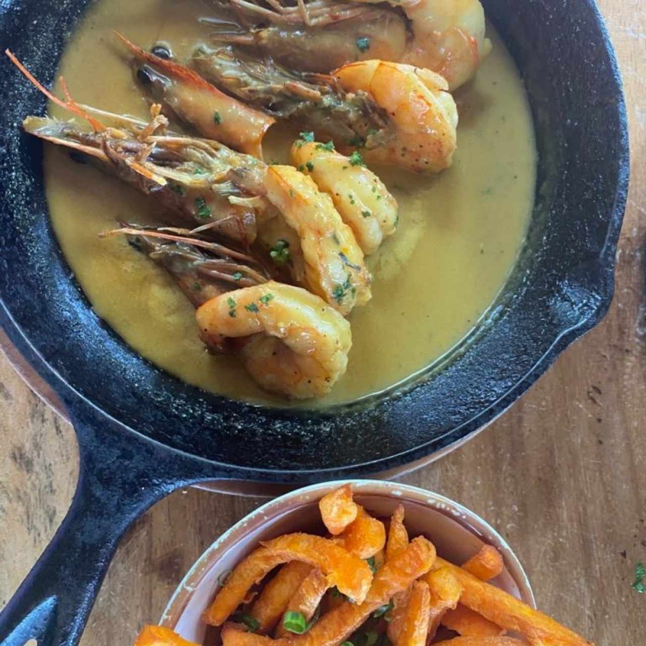 Langostinos al curry, una delicia acompañada de exquisito camote frito. 