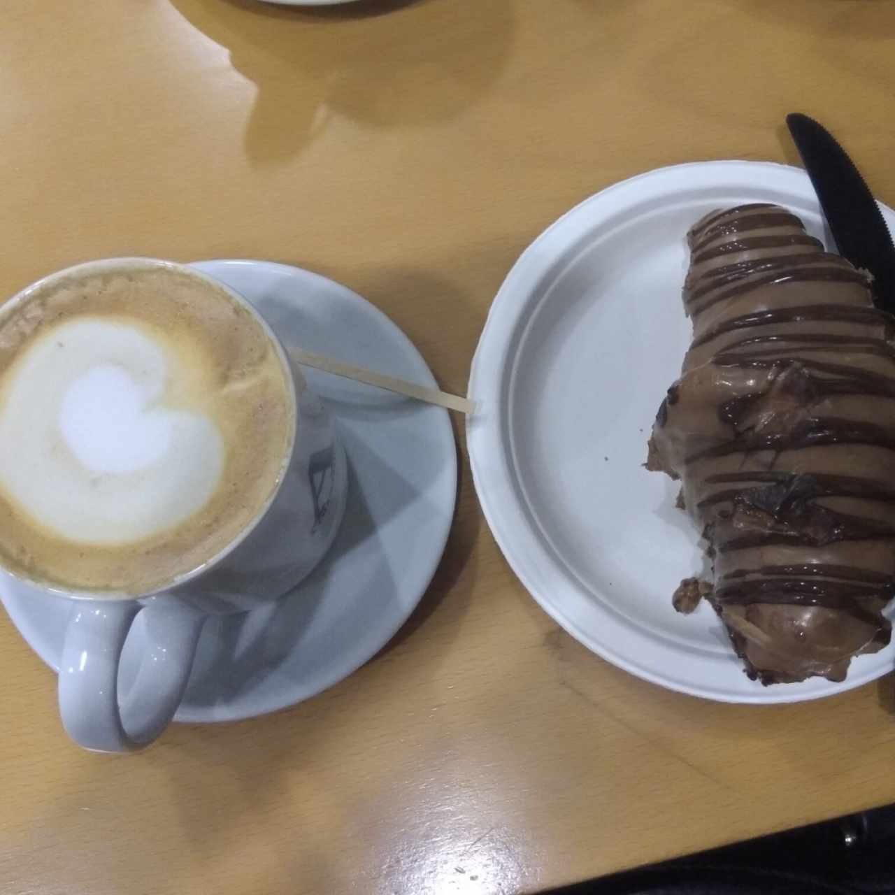 café con leche y croissant relleno de Nutella